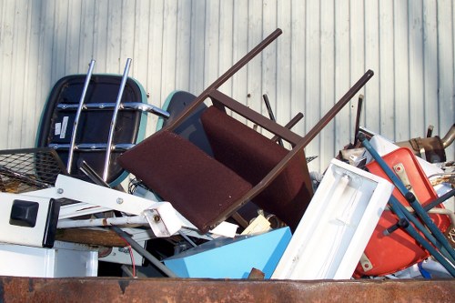 Staff placing materials into labeled recycling containers