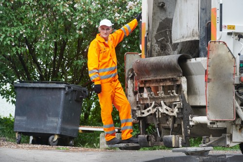 Workers handling builders waste clearance